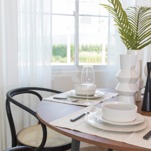 Dining room in a modern style with a round dining table with cha