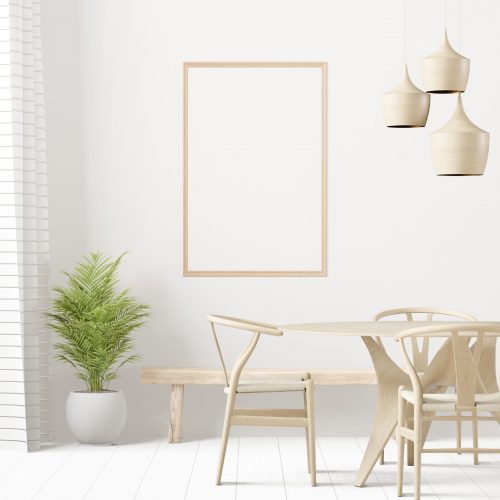 A set of tables and chairs in the room with a picture frame attached to wall.